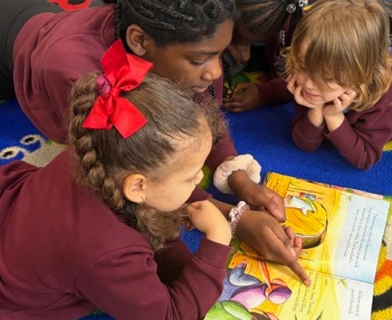 Students reading on the floor in a classroom