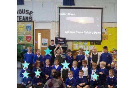 31 Y1 Harvest Assembly. Group of children in blue uniform.