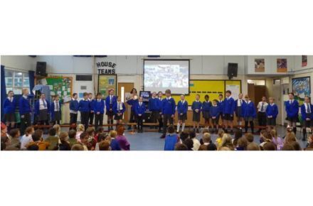 33 Y6 Assembly. Children presenting at front of hall.