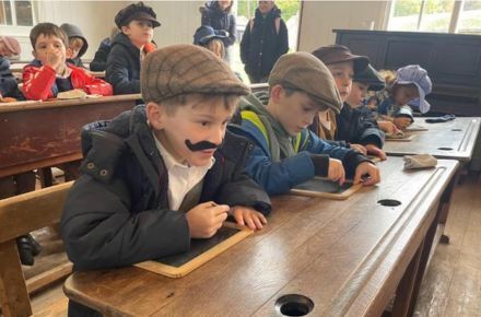 34 Y2 Rural Life Centre Visit. Pupils in period dress sat at desks.