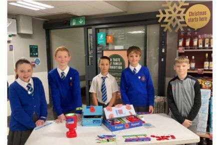 36 RRSA Waitrose Poppy Appeal. Group of pupils with campaign material.