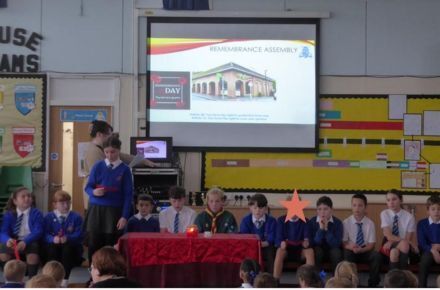 37 Y6 RRSA Poppy Appeal Assembly. Children presenting in front of screen.