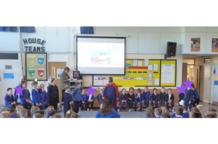 41 Y1 Rosen Class Assembly. Pupils in blue uniform at front of hall.