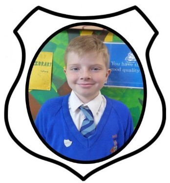 Year 6 Prefect. A picture of a boy smiling in blue school uniform