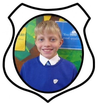 Year 6 Prefect. A picture of a boy smiling in blue school uniform