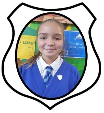 Year 6 Prefect. A picture of a girl smiling in blue school uniform