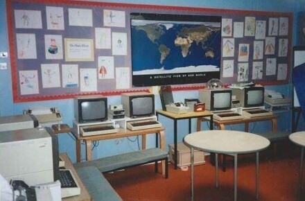 ICT suite 1994. Computer and monitors against backdrop of posters on wall.