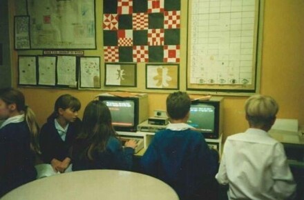 Working in the ICT Suite 1997. Pupils working at computers against backdrop of posters.