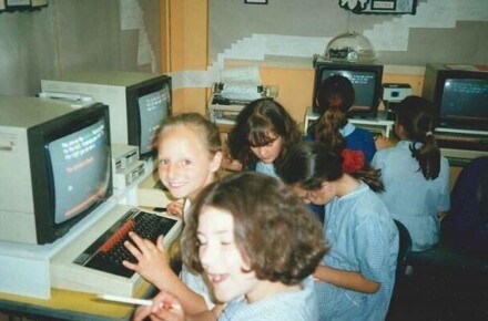 Y6 Working at Computers 1997. Pupils smiling at computers.