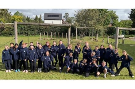 3 Y6 SATS Cheers! Pupil group outside on grass.