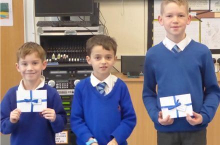 22 100% Attendance Winners. 3 boys in blue uniform.