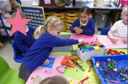 25 YR Donaldson Class Learning. Girls in blue uniform at table.