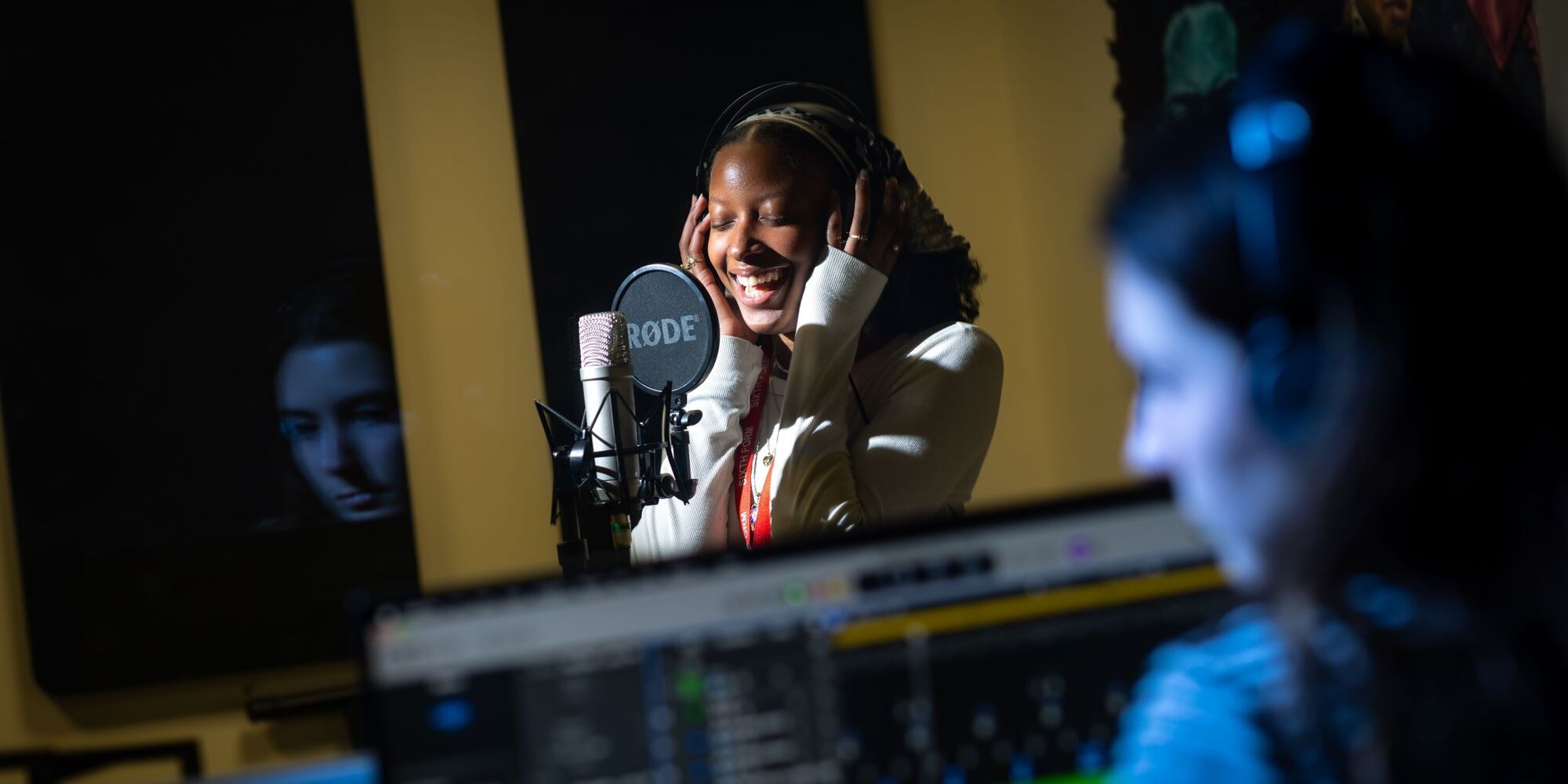 Female student singing in a recording studio